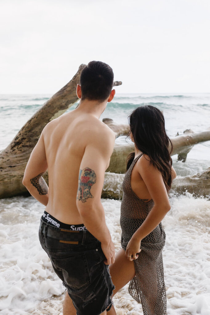 couple posing on a beach in hawaii
