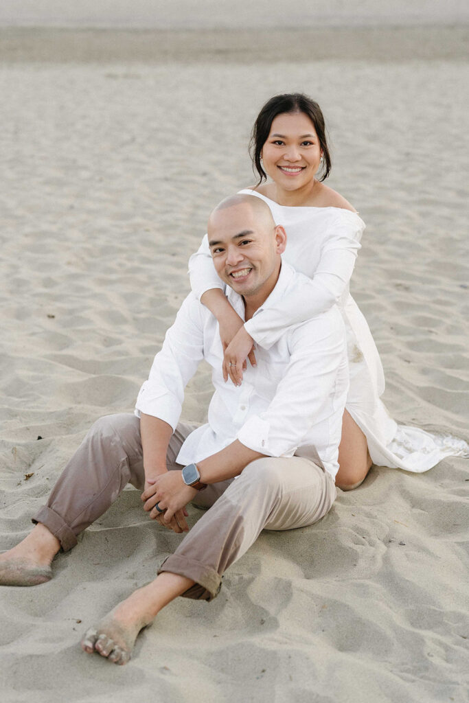 playful engagement photos for couples on the beach
