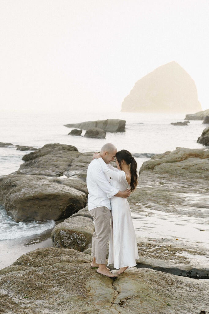 playful engagement photos for couples on the beach in cape kiwanda
