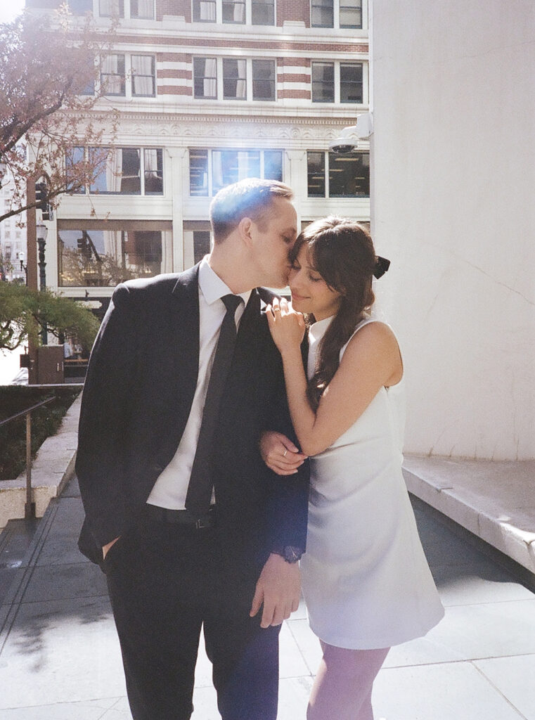 couples in downtown portland posing for their city engagement photos