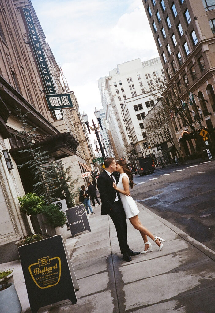 couples in downtown portland posing for their city engagement photos