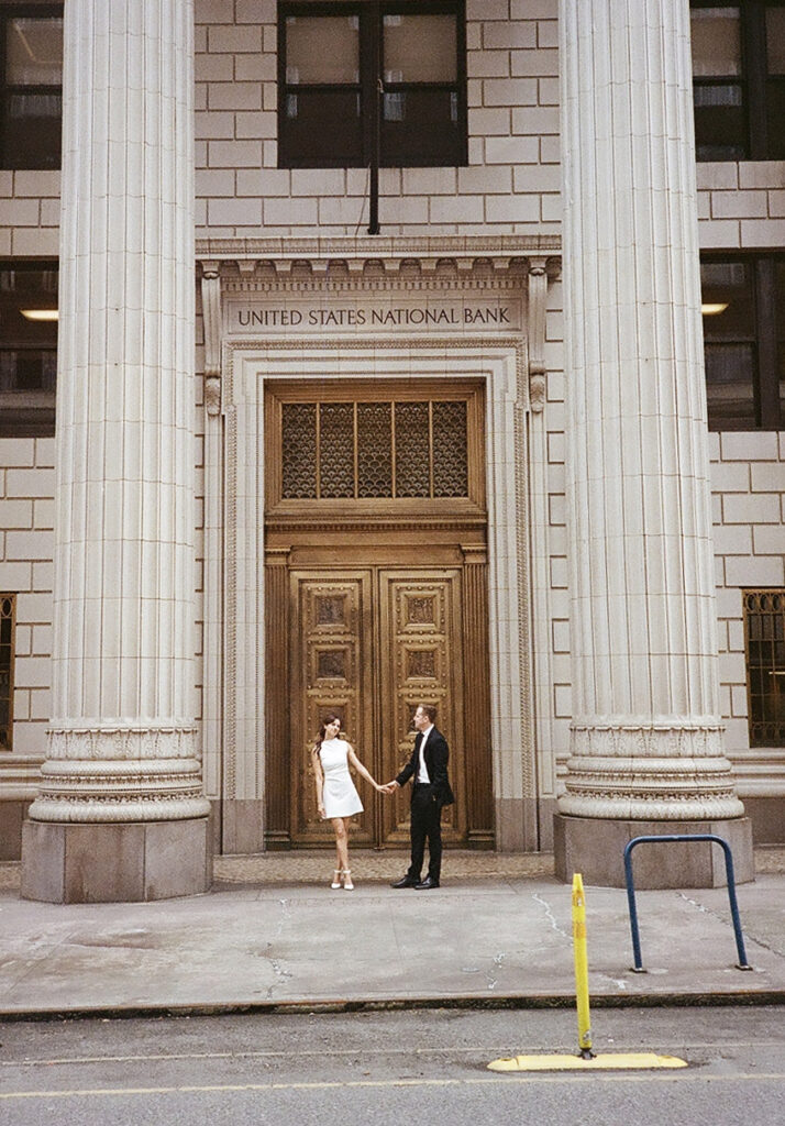 couples in downtown portland posing for their city engagement photos