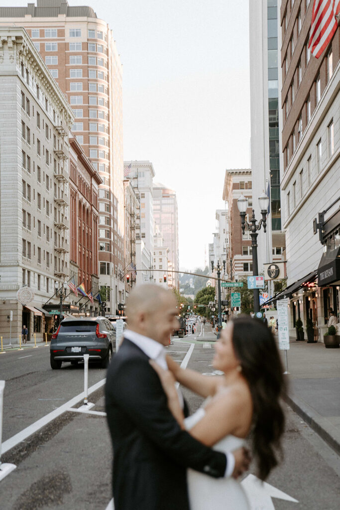 couples in downtown portland posing for their city engagement photos