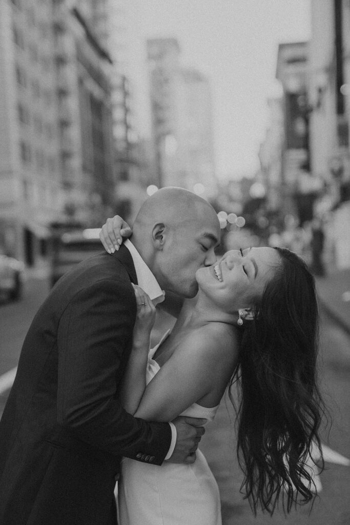 couples in downtown portland posing for their city engagement photos