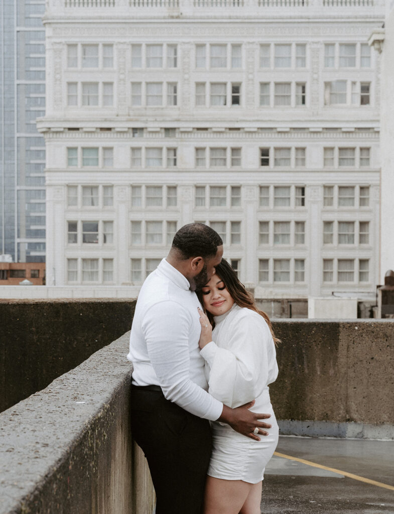 couples in downtown portland posing for their city engagement photos