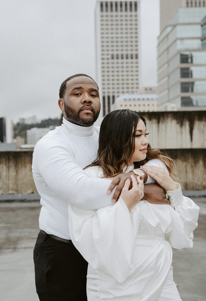 couples in downtown portland posing for their city engagement photos