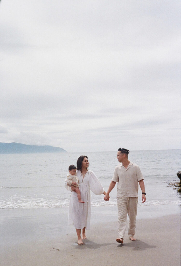 mom and dad posing with baby for their family session
