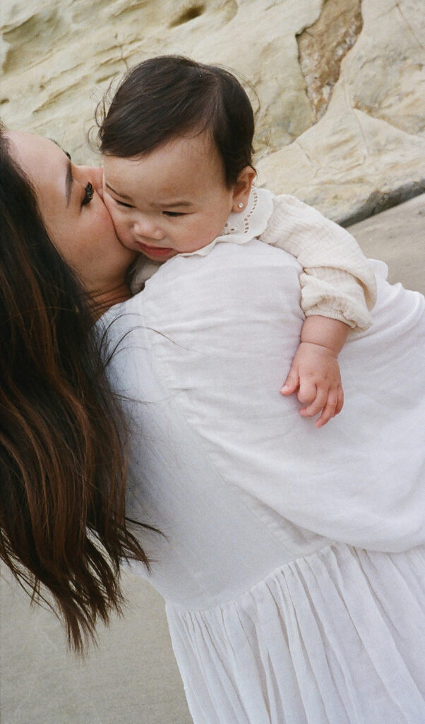 mom and dad posing with baby for their family session
