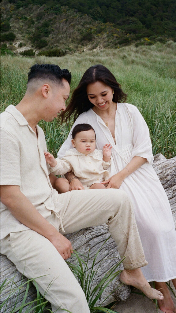 mom and dad posing with baby for their family session
