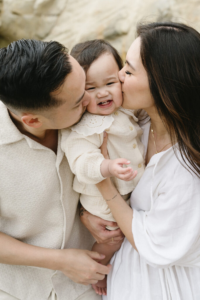 mom and dad posing with baby for their family session
