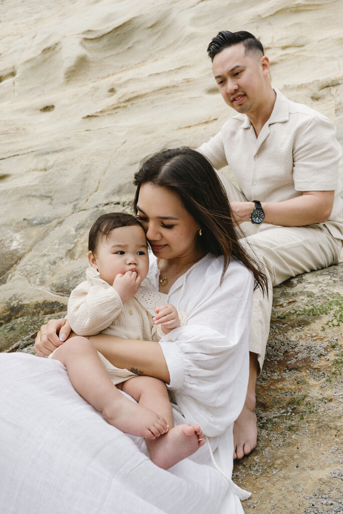 mom and dad posing with baby for their family session
