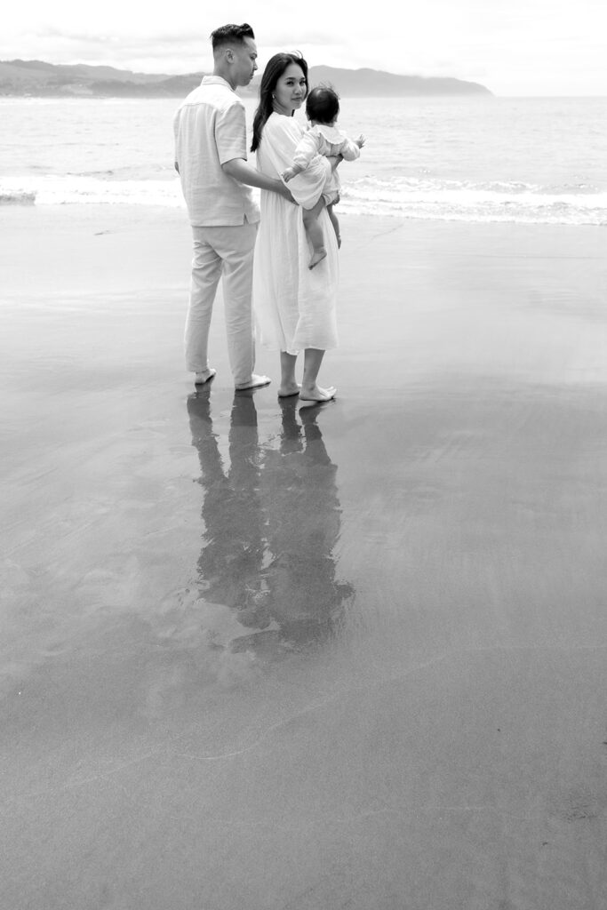 mom and dad posing with baby for their family session
