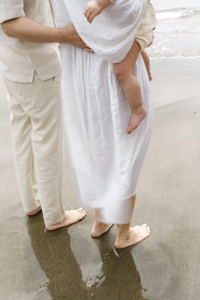 mom and dad posing with baby for their family session
