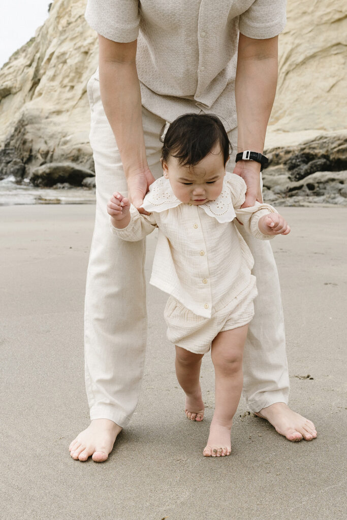 mom and dad posing with baby for their family session
