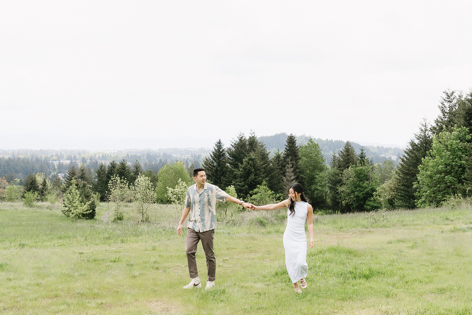 couple posing in a field for their engagement shoot