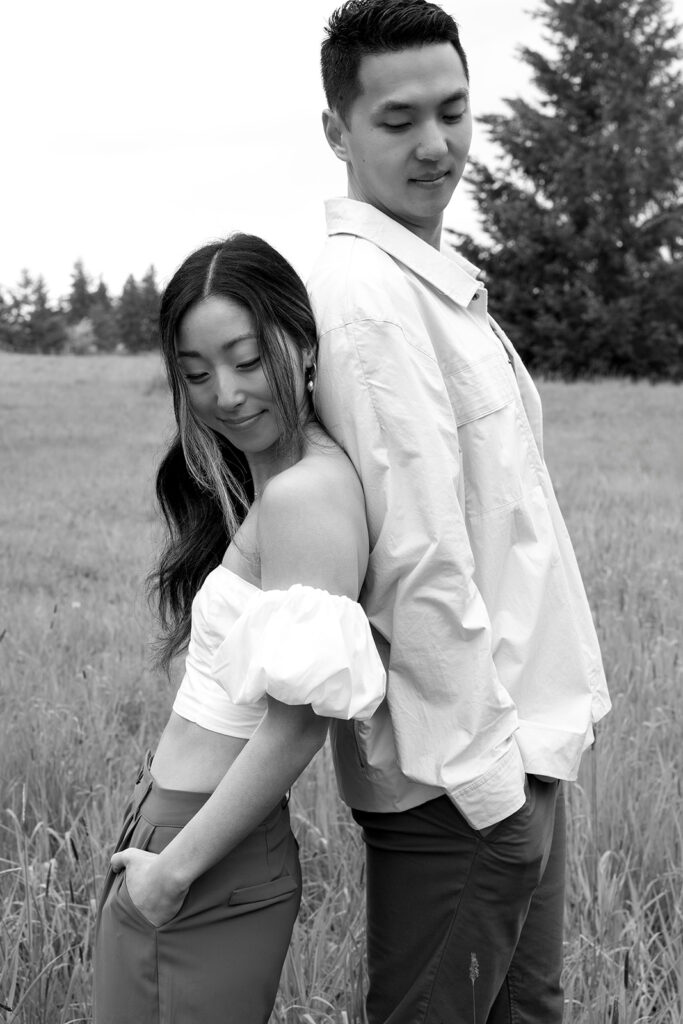 couple posing in a field for their engagement shoot
