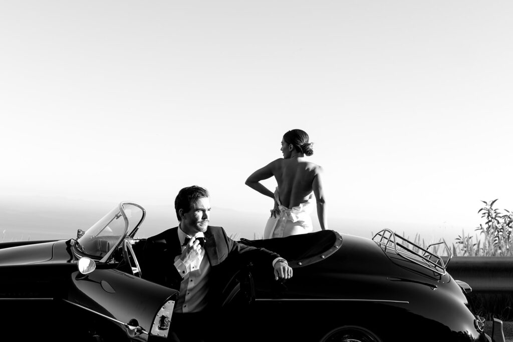 couple posing with a vintage car for their engagement photos
