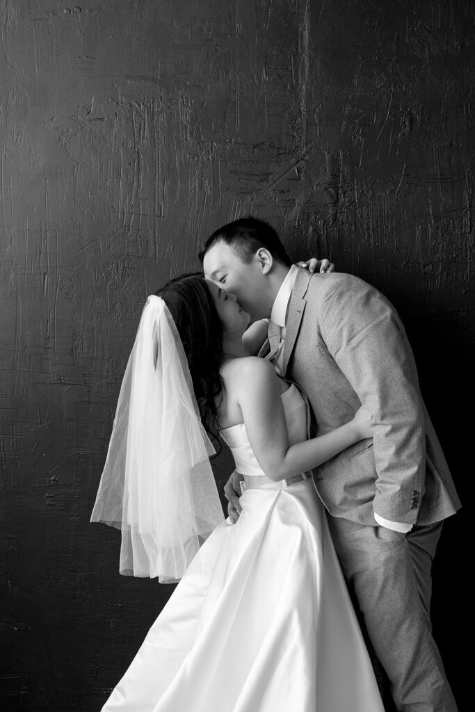 couple posing for a wedding photoshoot at a studio
