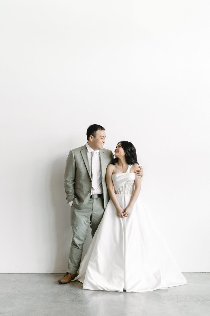 couple posing for a wedding photoshoot at a studio
