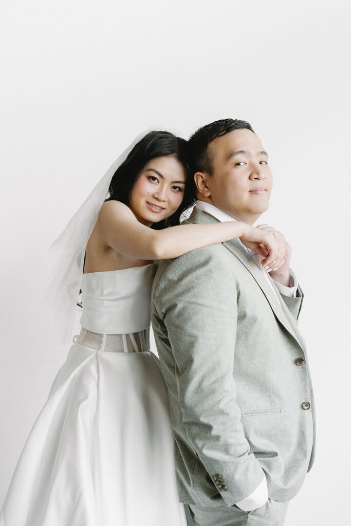 couple posing for a wedding photoshoot at a studio
