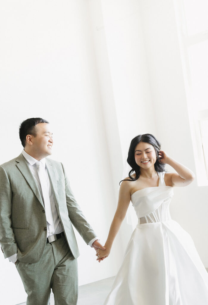 couple posing for a wedding photoshoot at a studio
