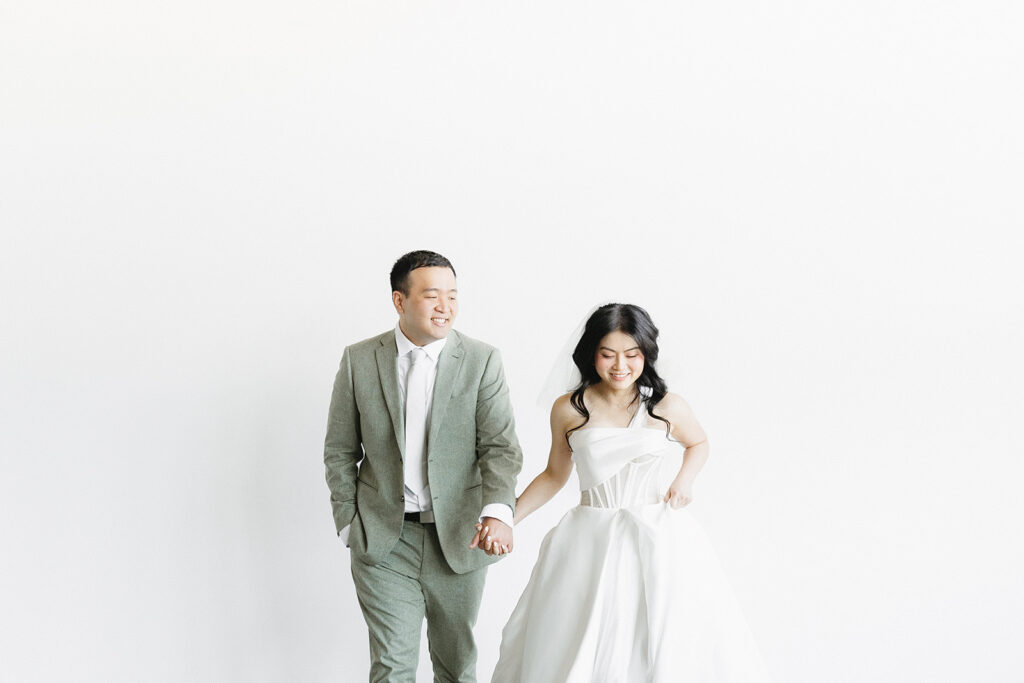 couple posing for a wedding photoshoot at a studio
