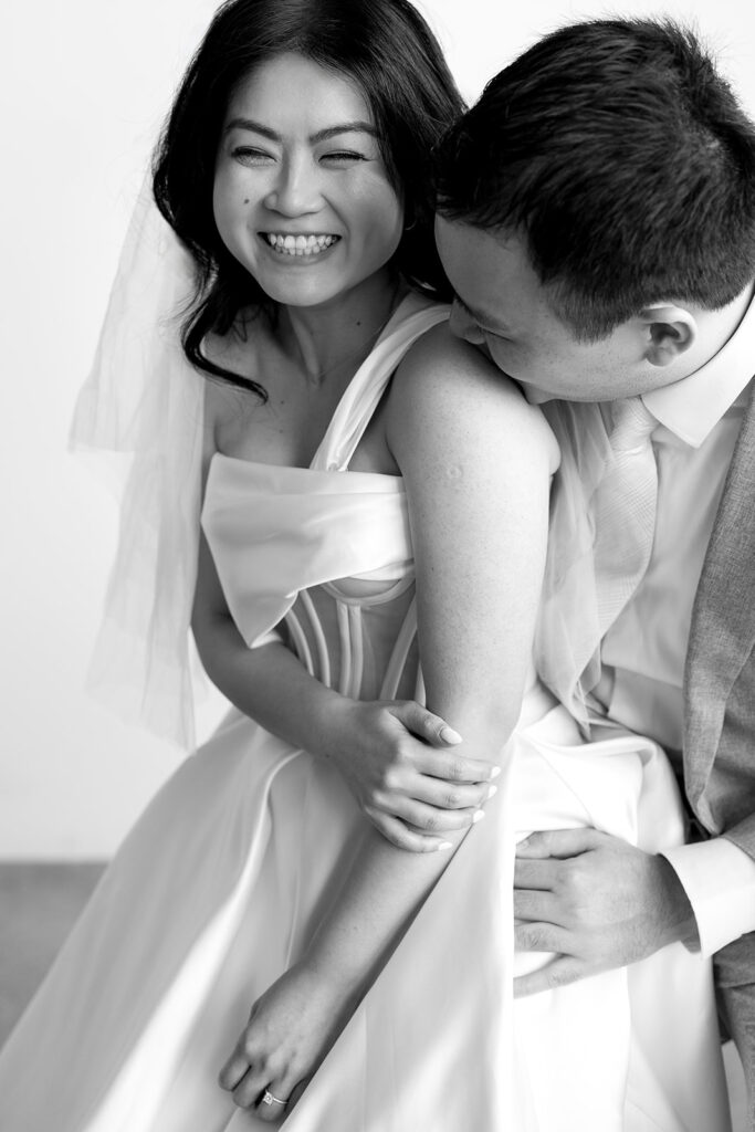 couple posing for a wedding photoshoot at a studio
