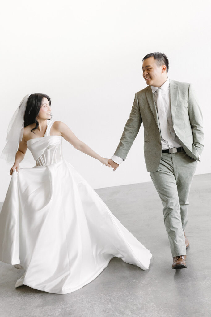 couple posing for a wedding photoshoot at a studio
