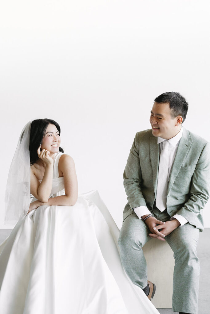 couple posing for a wedding photoshoot at a studio
