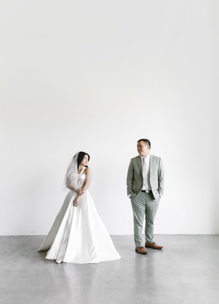 couple posing for a wedding photoshoot at a studio
