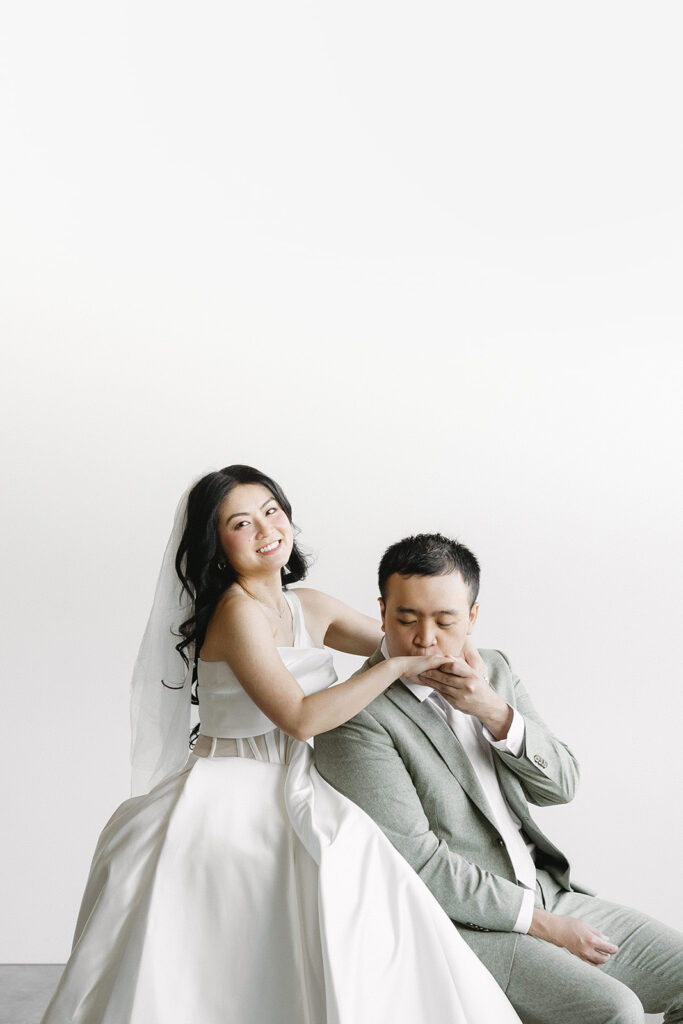 couple posing for a wedding photoshoot at a studio
