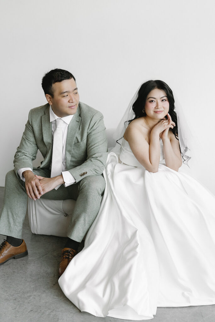 couple posing for a wedding photoshoot at a studio
