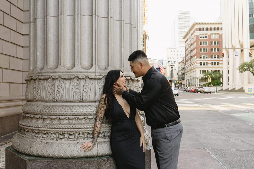 couple downtown taking engagement photos
