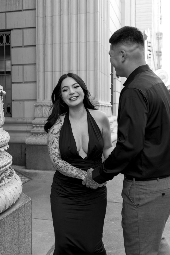 couple downtown taking engagement photos
