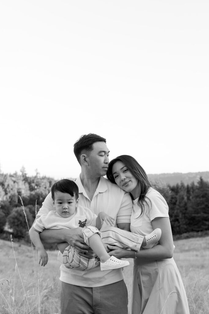 family taking photos in a field
