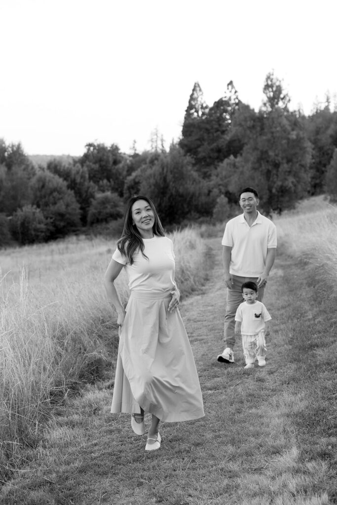 family taking photos in a field
