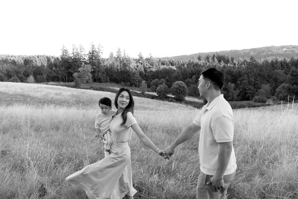 family taking photos in a field
