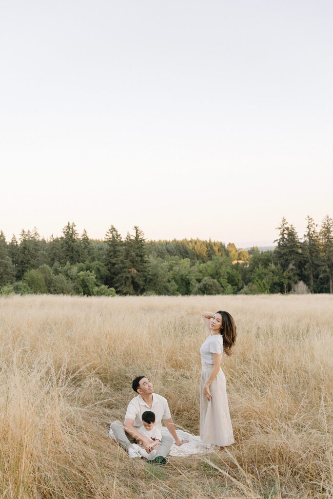 family taking photos in a field
