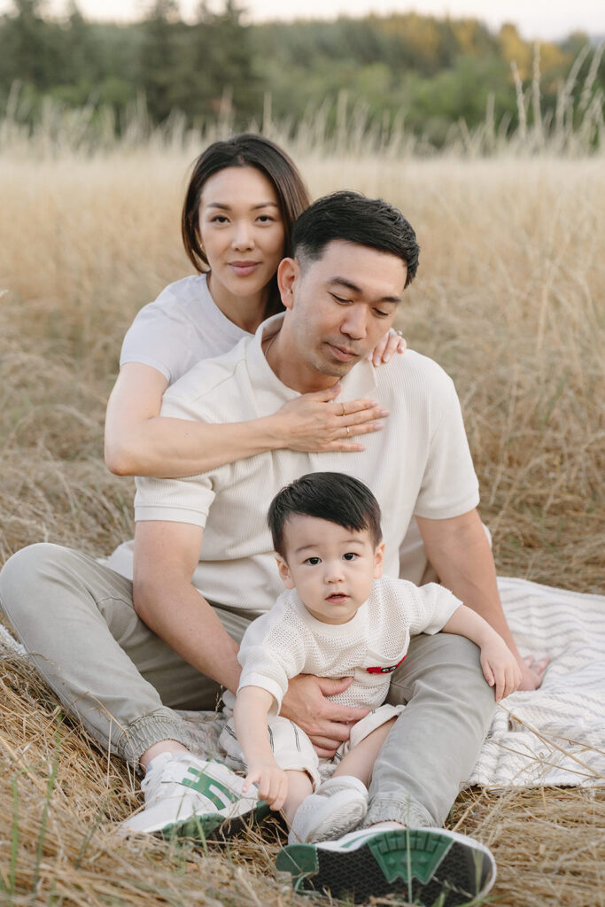 family taking photos in a field
