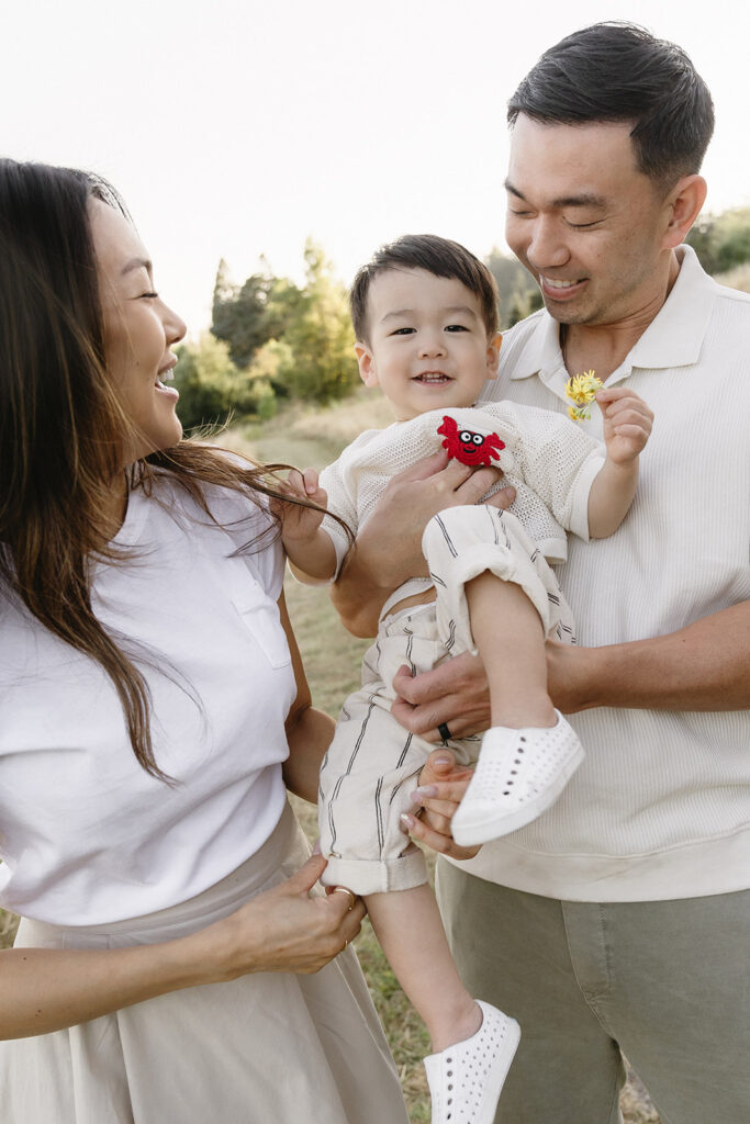 family taking photos in a field
