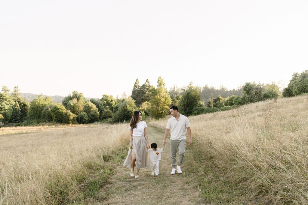 family taking photos in a field
