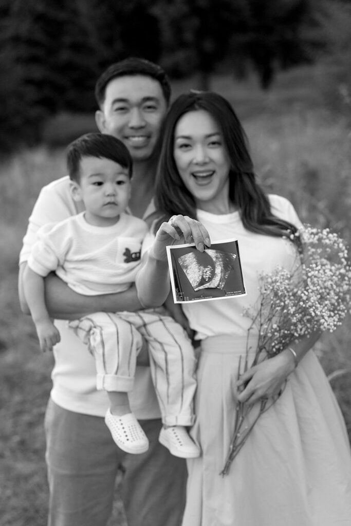 family taking photos in a field
