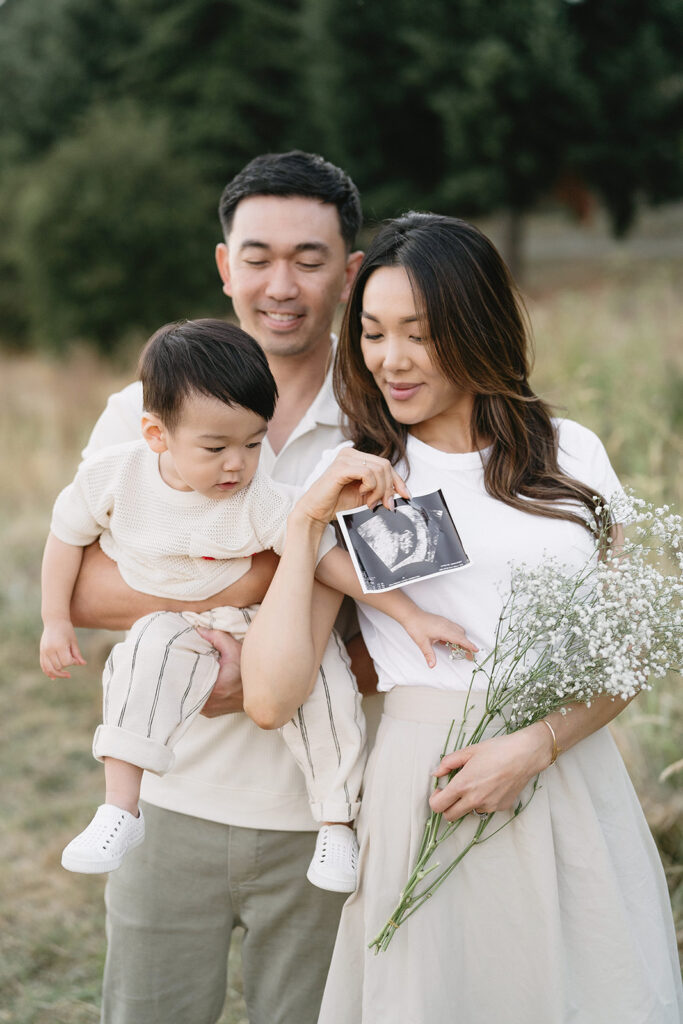 family taking photos in a field
