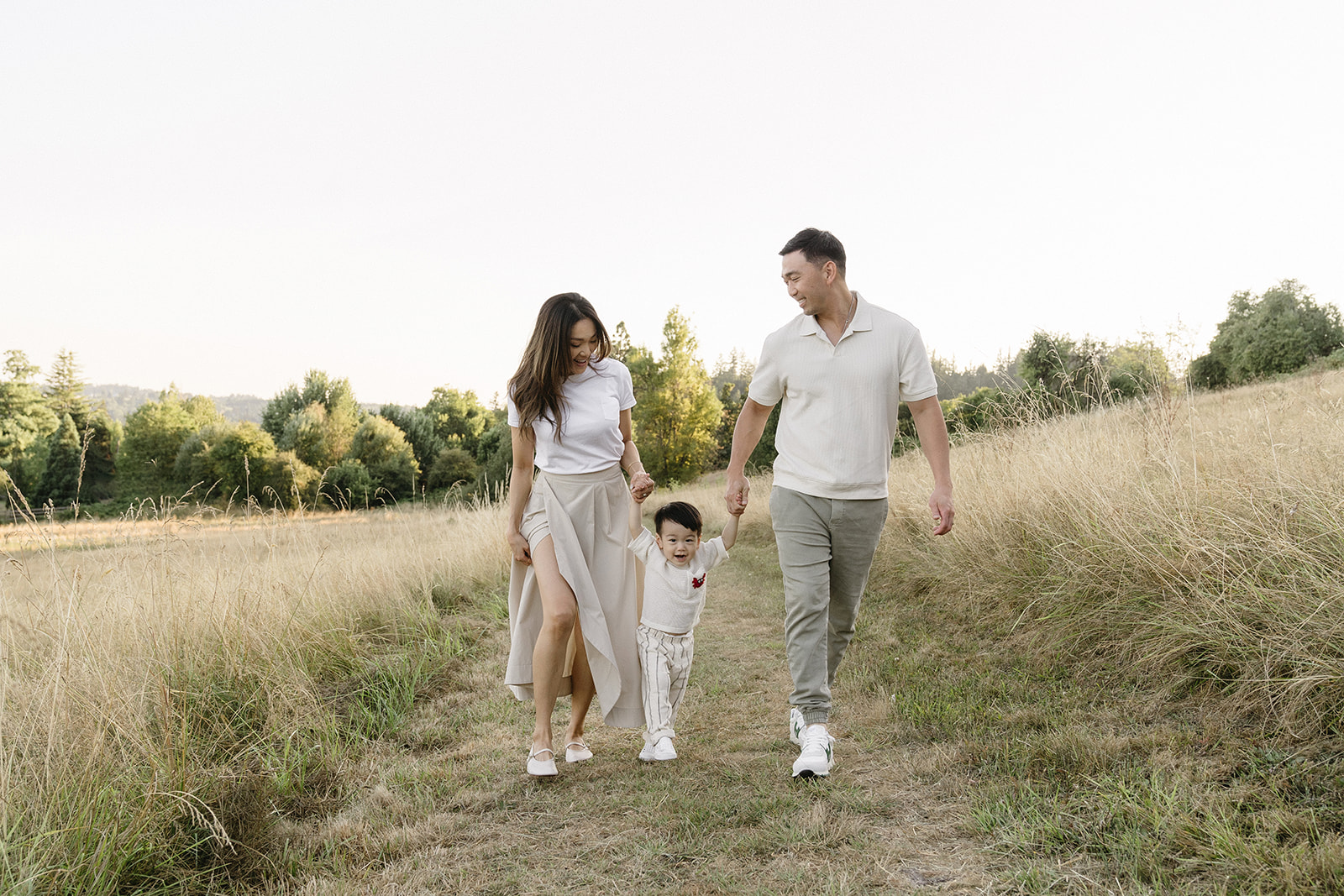 family taking photos in a field