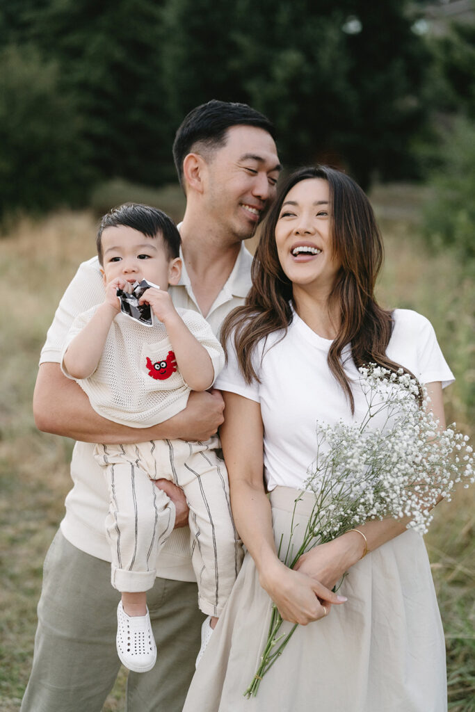 family taking photos in a field
