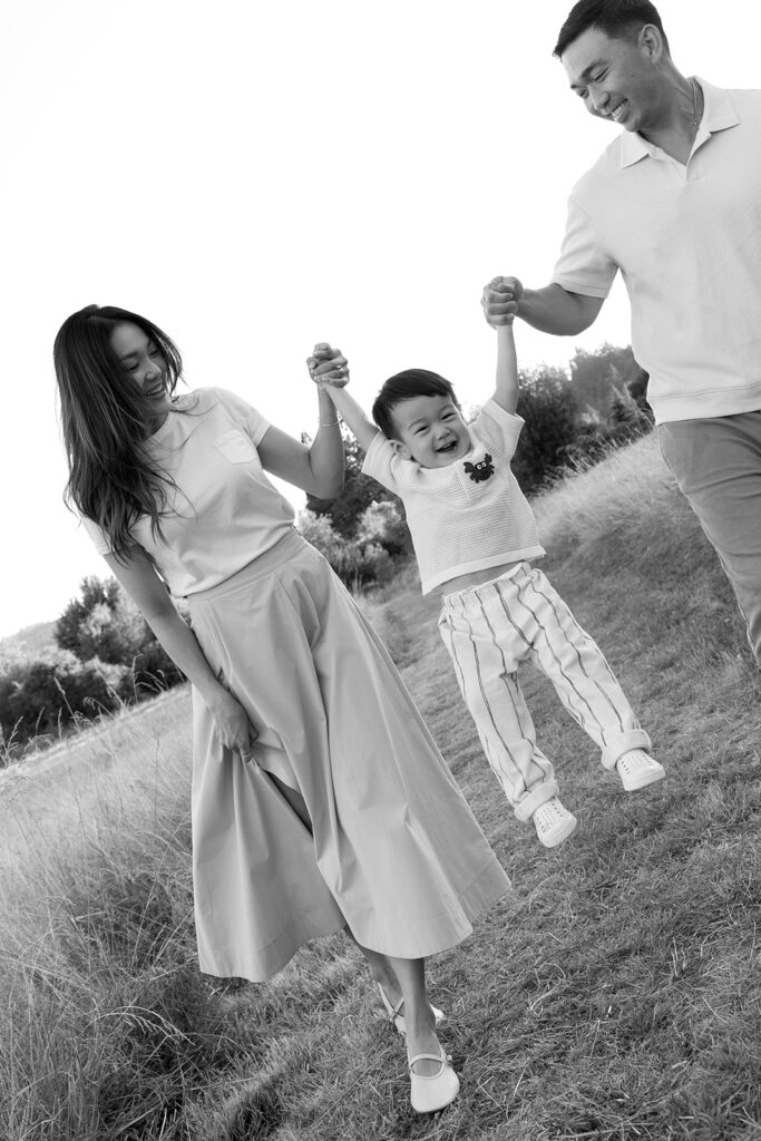 family taking photos in a field
