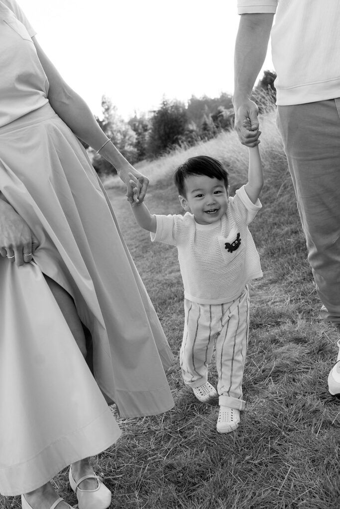 family taking photos in a field
