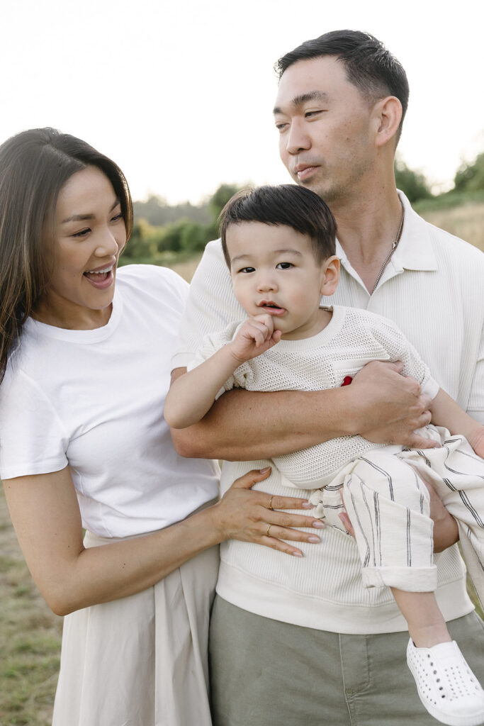 family taking photos in a field
