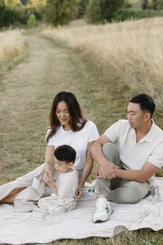 family taking photos in a field
