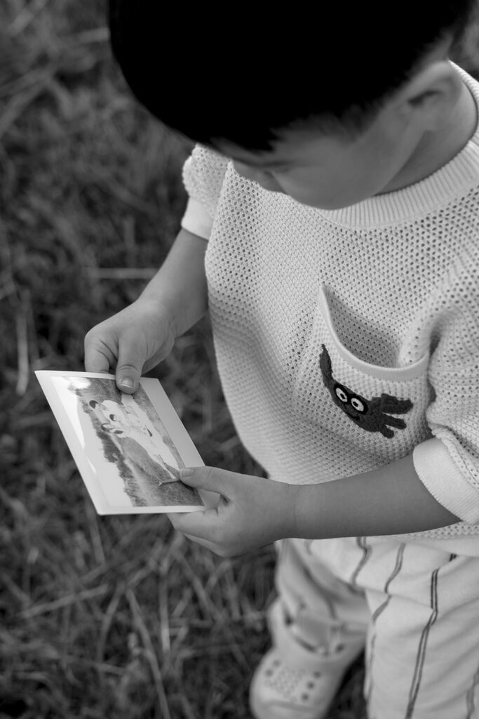 family taking photos in a field
